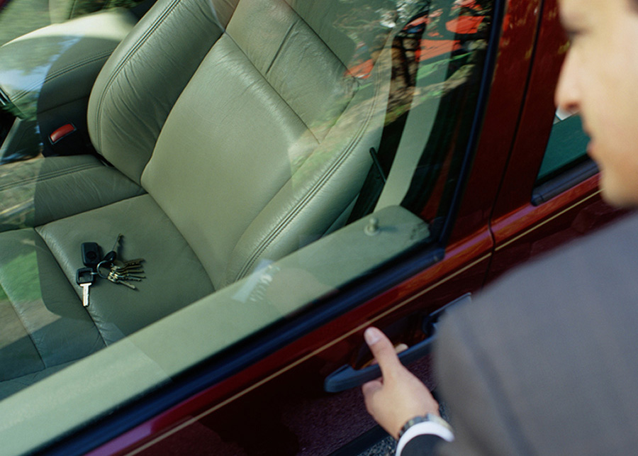 Businessman Looking at His Keys Locked in the Car
